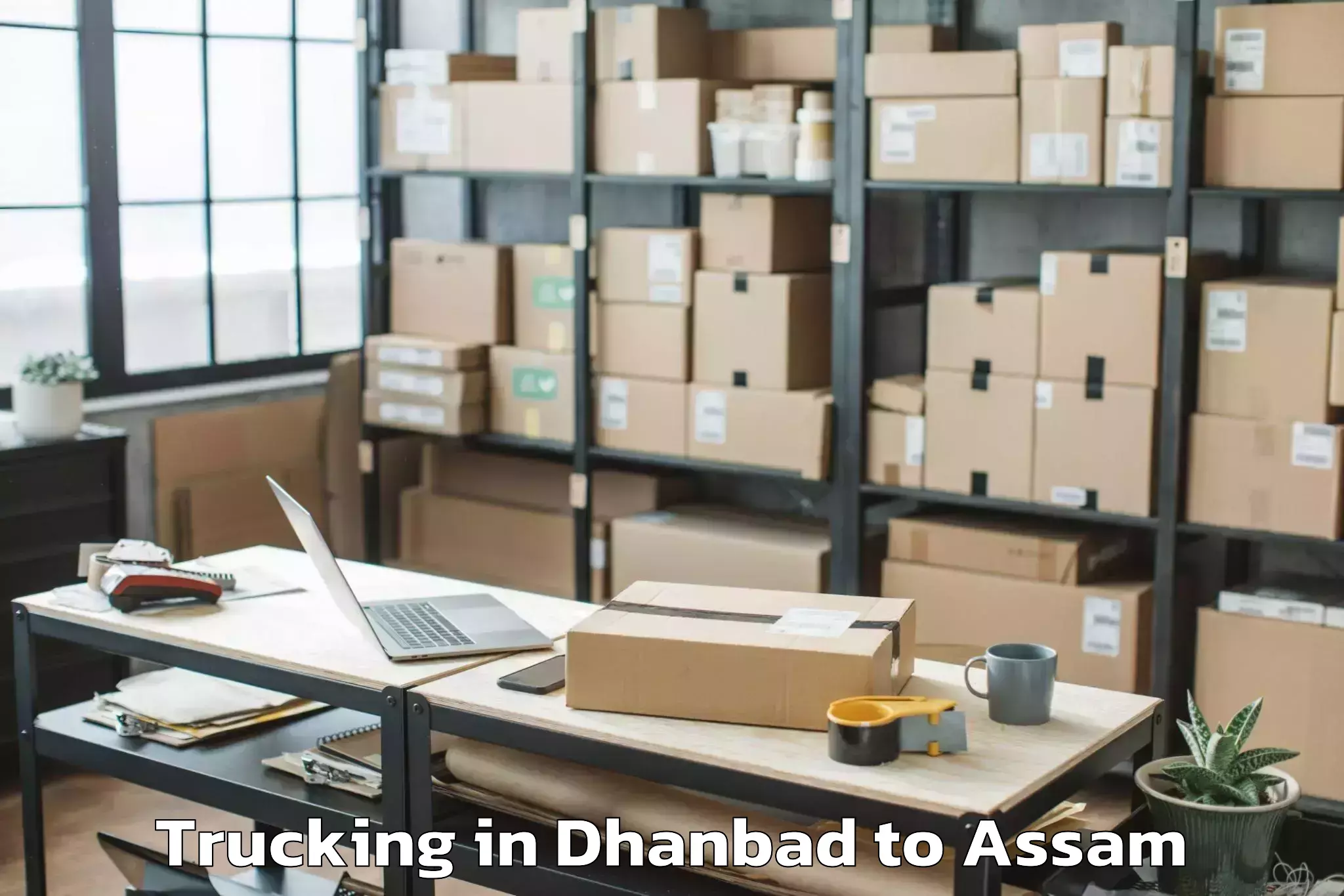 Dhanbad to Sarthebari Trucking Booking